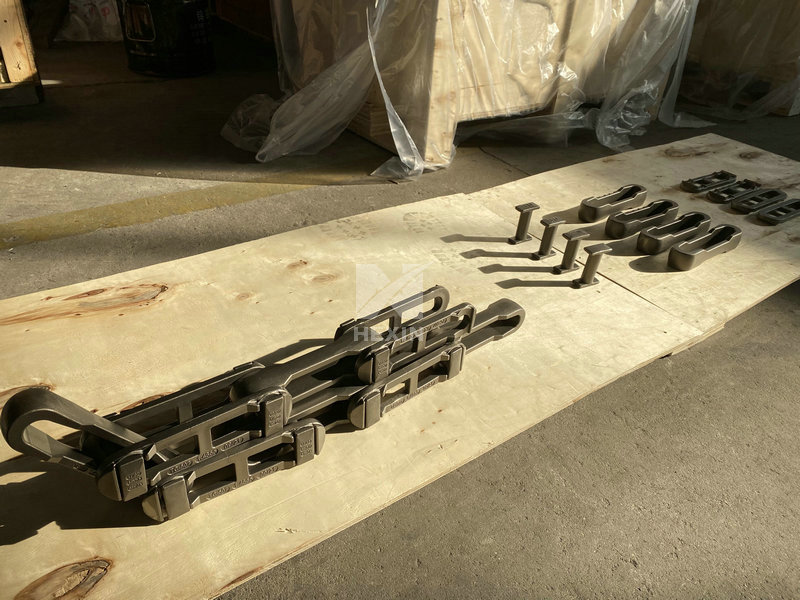 Investment cast alloy belt assembly